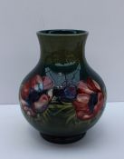 A Moorcroft pottery vase decorated in the Anemone pattern to a graded green ground, 19.5cm high,