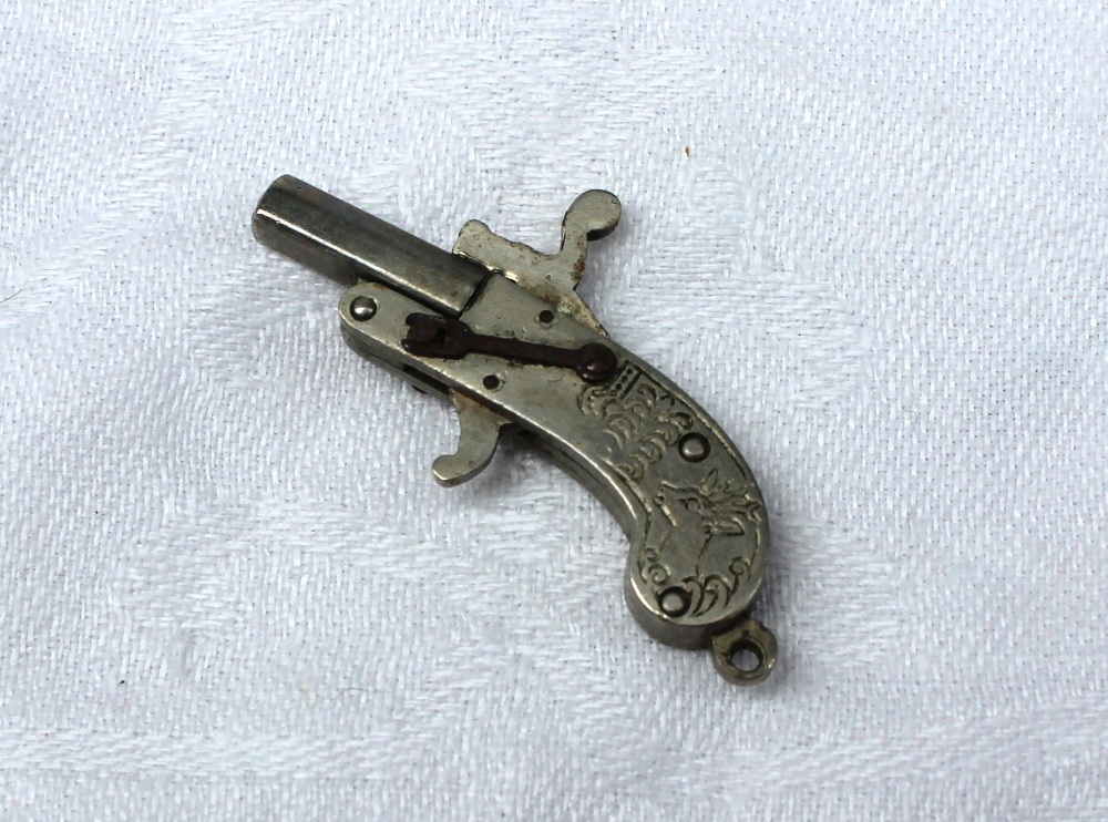 A miniature pistol engraved to one side with the head of a stag, to the other with a rabbit, 3. - Image 3 of 4