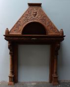 A 19th century oak fire surround carved with lions masks and scrolling leaves ,