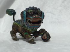 A Chinese cloisonne over wirework dog of foo the wirework body overlaid with vibrant coloured
