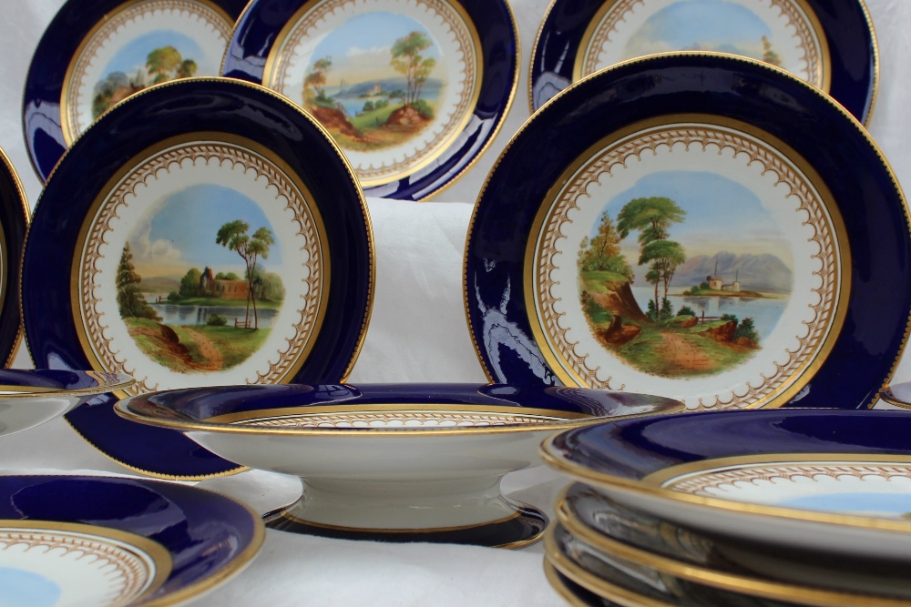 A 19th century porcelain dessert set each piece painted with landscape scenes within a Royal blue - Image 2 of 10