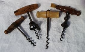 A Victorian T bar corkscrew with turned wooden handle, brush to one end,