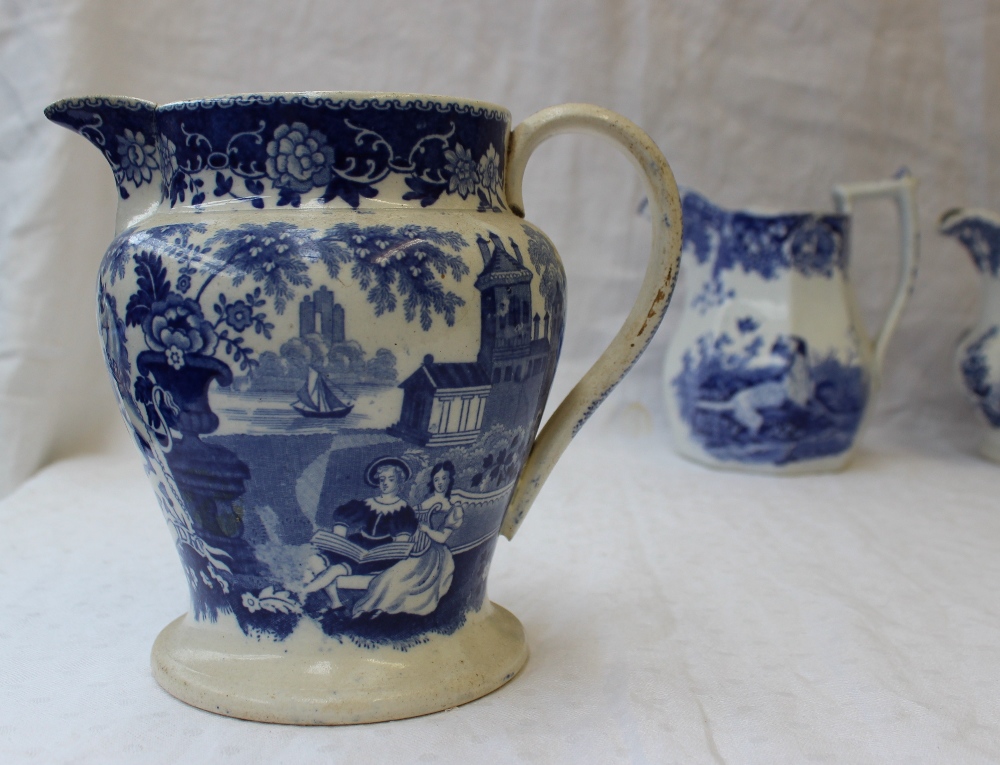 A 19th century pottery jug with blue and white transfer decoration of a setter with a game bird in - Image 2 of 9