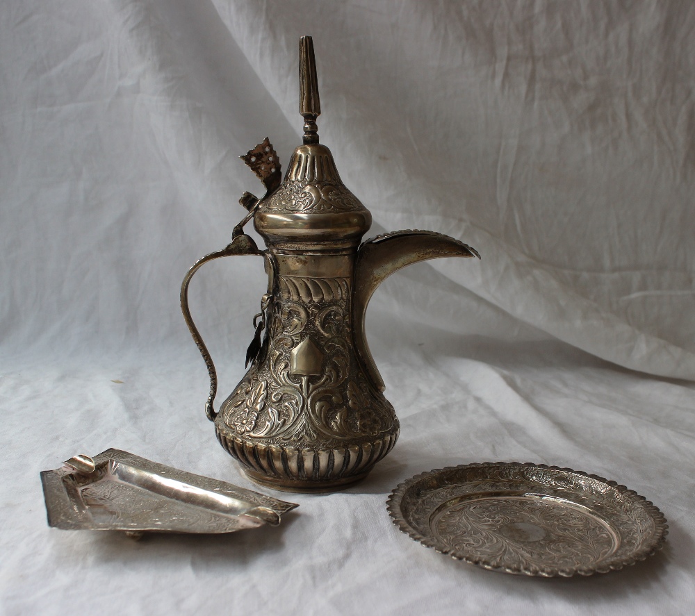 A white metal teapot, with a domed pointed lid, the body embossed with leaves and flowers, - Image 2 of 8