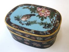 A Japanese Cloisonne box and cover, the lid decorated with a bird and insects amongst a floral bush,