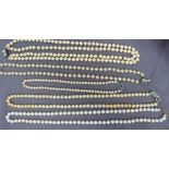 A pearl necklace set with eighty regular individually knotted pearls to a yellow metal clasp,