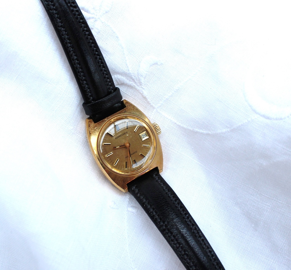 Longines - A Lady's yellow metal Longines automatic wristwatch, the gilt dial with date aperture and