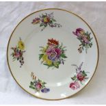 A 19th century porcelain plate painted with sprays of garden flowers within a gilt border, gilt