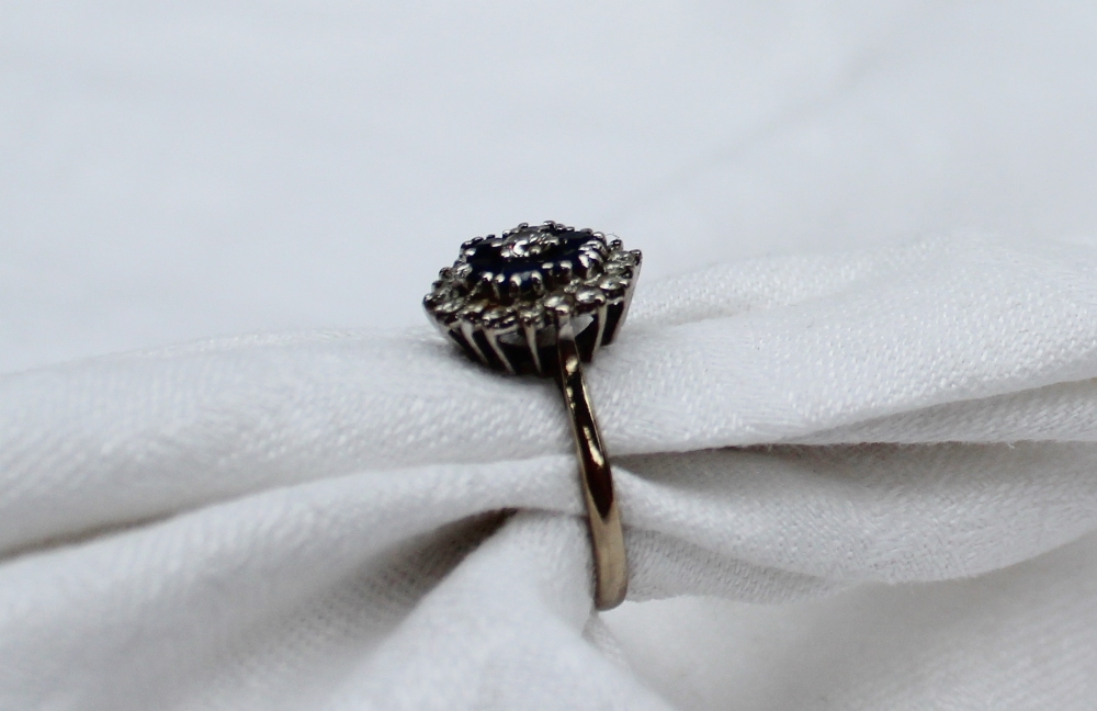 A sapphire and diamond dress ring, set with a central round brilliant cut diamond approximately 0. - Image 2 of 4