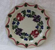 A Dillwyn pottery plate decorated in the Persian Rose pattern, with green leaves and pink and purple