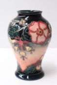 A Moorcroft pottery vase decorated in the Oberon pattern to a graded colour ground, 16cm high,