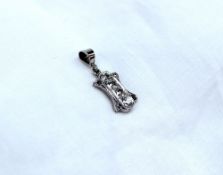 A small diamond pendant, set with four old cut diamonds in a line,