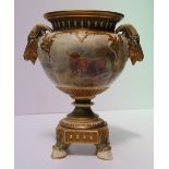 A Royal Worcester porcelain twin handled vase, with a flared rim, with twin rams head handles, the
