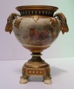 A Royal Worcester porcelain twin handled vase, with a flared rim, with twin rams head handles, the