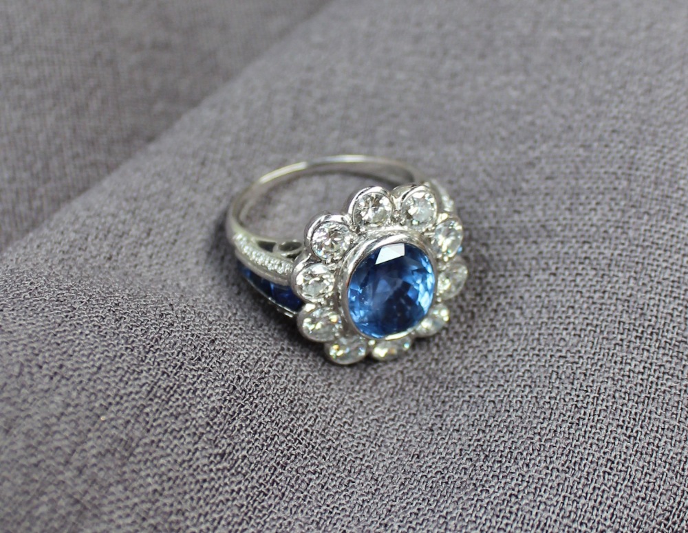 A sapphire and diamond cluster ring, the central sapphire measuring approximately 10mm by 8mm, - Image 6 of 7