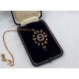 An Edwardian Sapphire and seed pearl pendant of leaf form, mounted in yellow metal mount marked