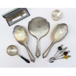 A silver backed hand mirror, together with two silver backed hair brushes,