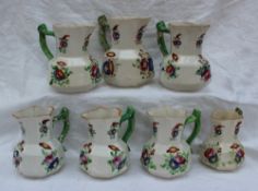 A matched set of seven Dillwyn pottery jugs of octagonal panelled form painted with sprays of
