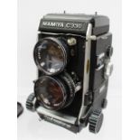 A Mamiya C330 TLR camera, together with additional lenses,