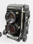 A Mamiya C330 TLR camera, together with additional lenses,
