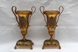 A pair of 19th century gilt and enamel decorated twin handles vases of urn shape on rectangular