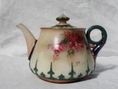 A Hadley's Worcester teapot and cover, with raised decoration of pointed leaves, the body transfer
