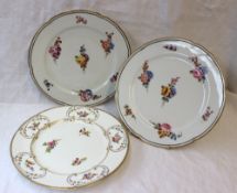 A pair of continental porcelain plates with a scalloped gilt border with an internal line and dash