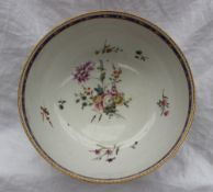 A Chelsea Derby porcelain bowl with a gilt scalloped rim, the centre painted with sprays of garden