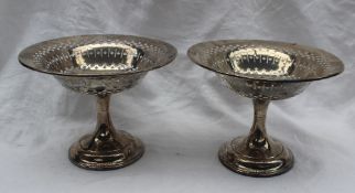 A pair of George VI silver pedestal bon bon dishes, with pierced rim, on a tapering column and