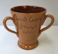 A Clay Pits Ewenny Studio Pottery tyg, inscribed "Cariad Cwpan Fel Yn 1670", to a mustard yellow