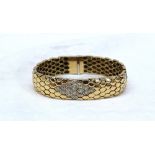 An 18ct yellow gold and diamond set bracelet of snake skin effect,