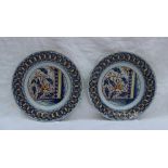 A pair of 19th century tin glazed earthenware plates, decorated with leaves and flower heads, the