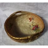 A Royal Worcester porcelain bowl moulded in the form of a basket with twin gilt decorated handles,