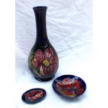 A Moorcroft pottery baluster vase decorated in the Clematis pattern to a blue ground, 27.