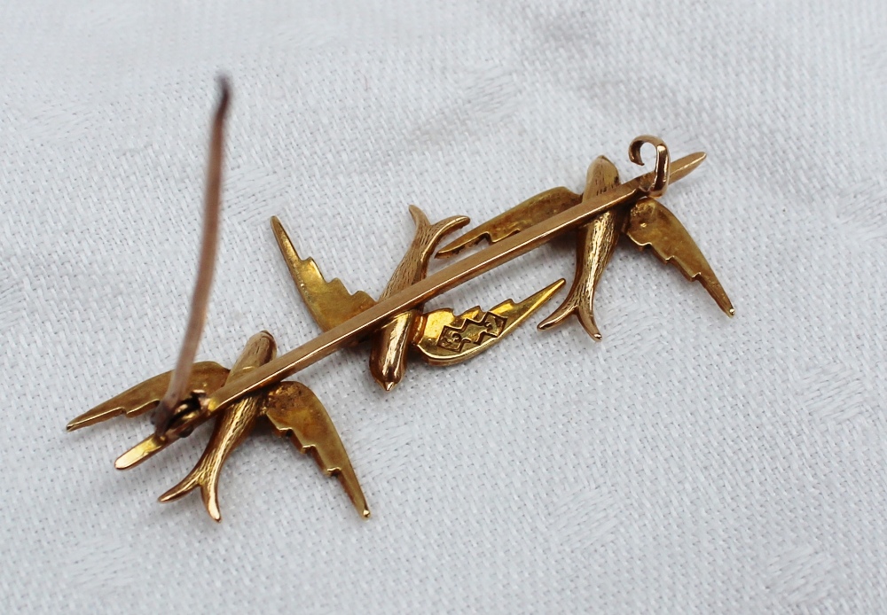 A yellow metal bar brooch in the form of three swallows, set with seed pearls, marked 15c, - Image 3 of 3