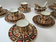 A Royal Crown Derby part coffee set comprising a cream jug, six coffee cans, six saucers, six side