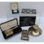 A George VI silver hairbrush, London, 1947, cased, together with a silver desk inkwell,