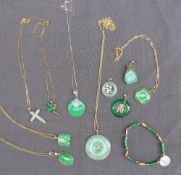 A green hardstone pendant of circular form together with a collection of similar pendants, bracelet,