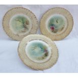 A set of three Minton porcelain plates painted with fish, seaweed and the seabed, initialled A.H.