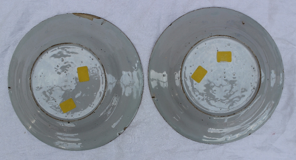 A pair of 19th century tin glazed earthenware plates, decorated with leaves and flower heads, the - Image 3 of 3