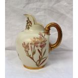 A Royal Worcester porcelain flatback jug, transfer and infil decorated with flowers and leaves, with