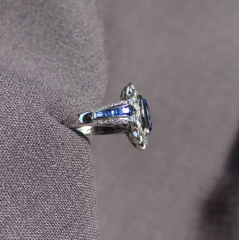 A sapphire and diamond cluster ring, the central sapphire measuring approximately 10mm by 8mm, - Image 5 of 7