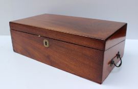 A Victorian mahogany lap top desk, the rectangular hinged top enclosing a sloping writing fall,