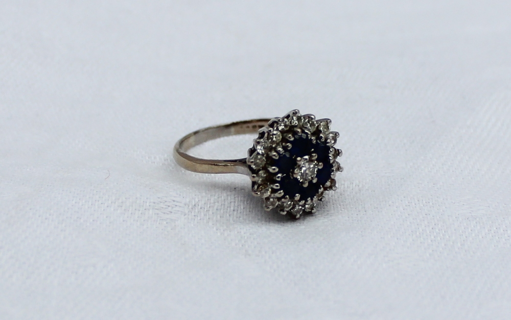 A sapphire and diamond dress ring, set with a central round brilliant cut diamond approximately 0. - Image 3 of 4