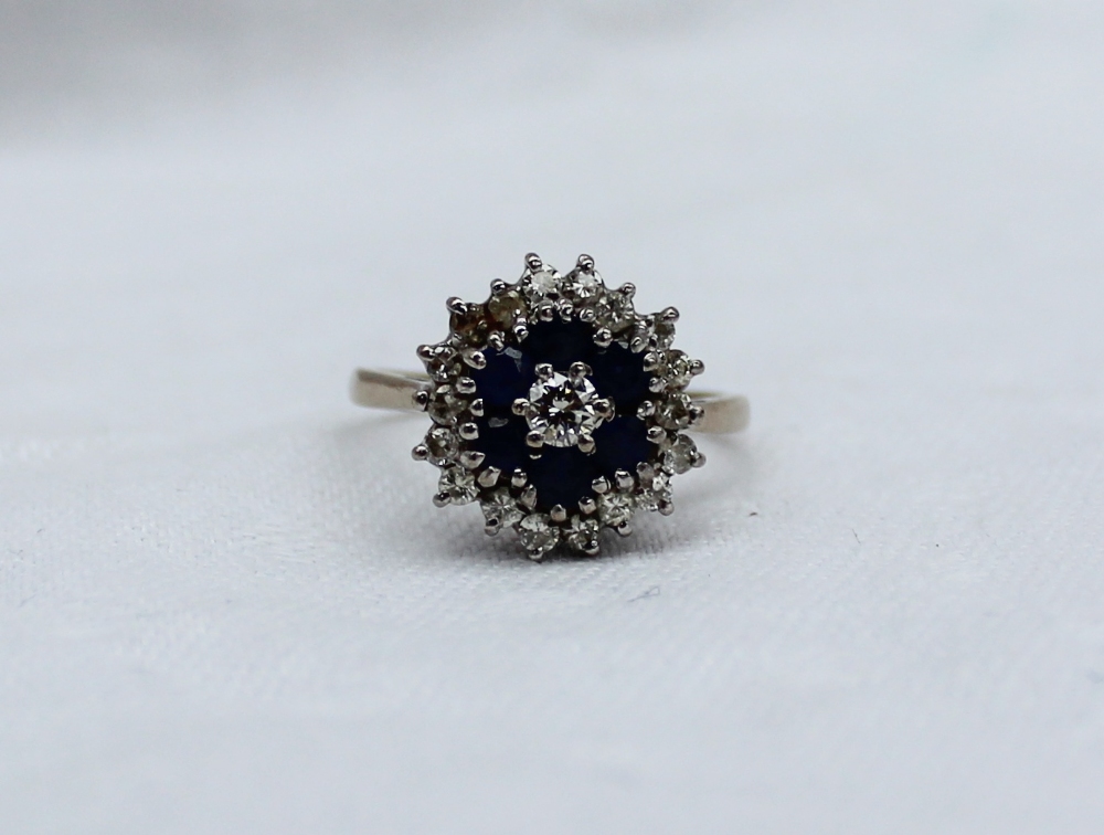 A sapphire and diamond dress ring, set with a central round brilliant cut diamond approximately 0. - Image 4 of 4