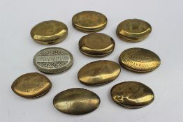 A collection of late 19th / early 20th century oval and circular brass and base metal tobacco twist