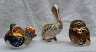 Three Royal Crown Derby paperweights including a Mandarin Duck, Little Owl and White Pelican,