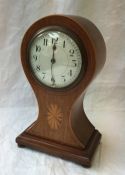 An Edwardian mahogany balloon shaped mantle clock, the circular dial with Arabic numerals,