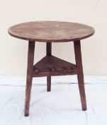 A 19th century oak cricket table with a circular planked top on triangular legs united by an
