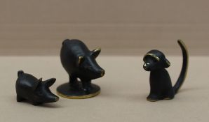 A set of three miniature bronze animalia models including a monkey and two pigs,